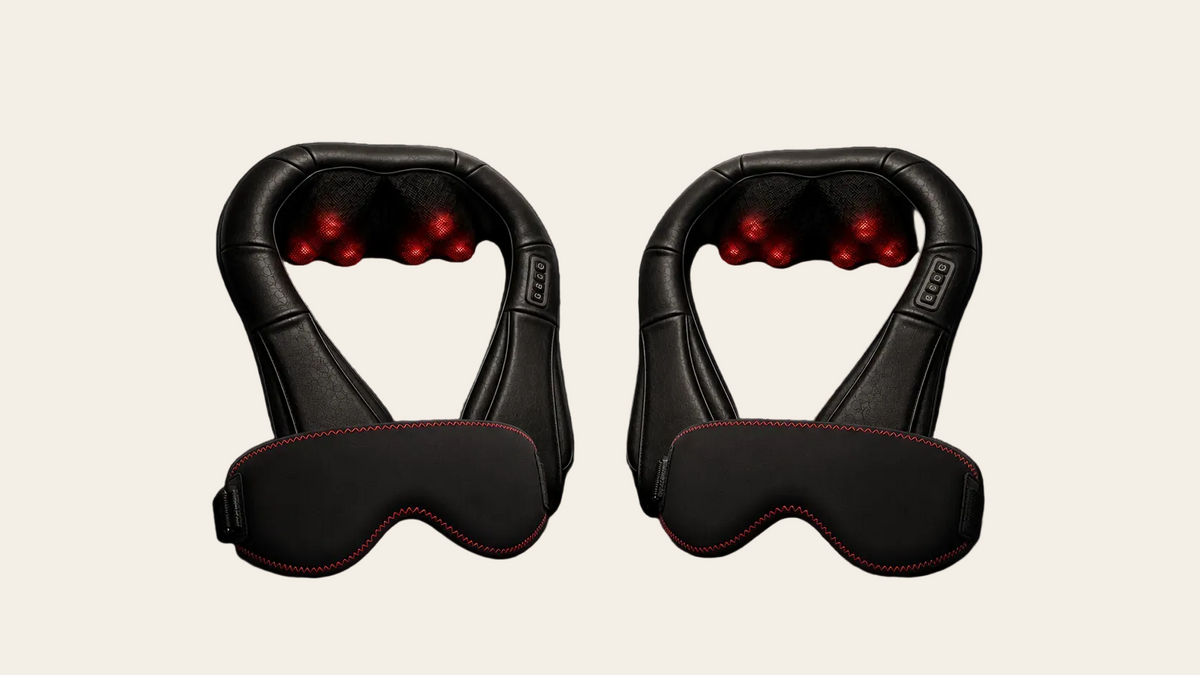 Two black neck and eye massage devices with red LED lights and red contrast stitching, displayed side-by-side on a dark reflective surface against a dark background.